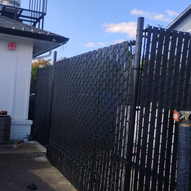 Black vinyl-coated chain link fence installation