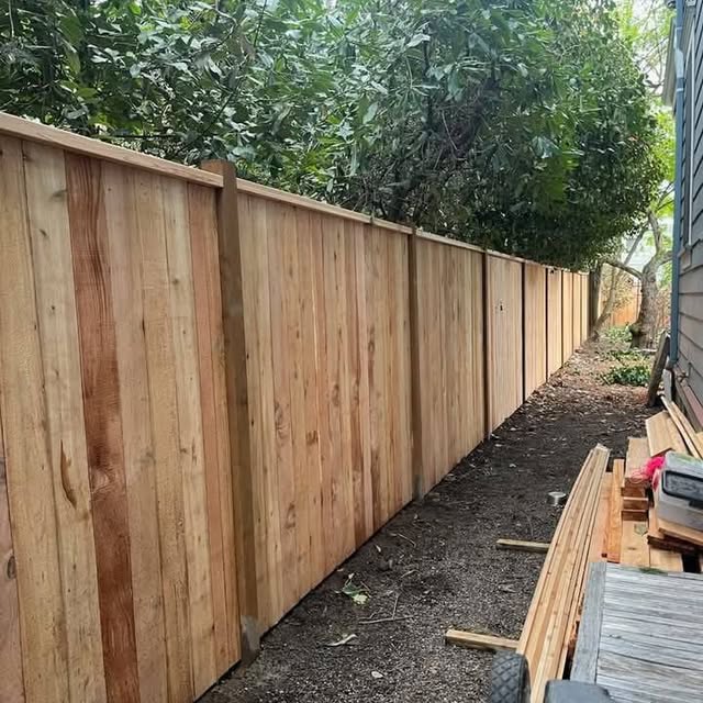 Cedar wood privacy fence installed along a narrow yard